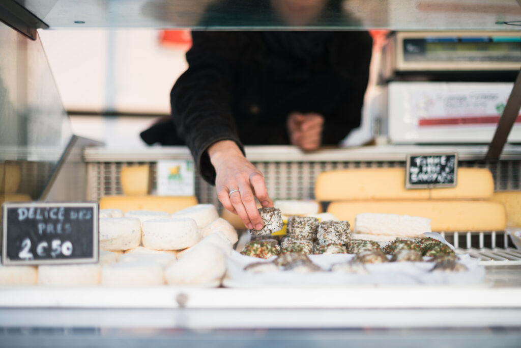 productrice rangeant fromages bio dans étal